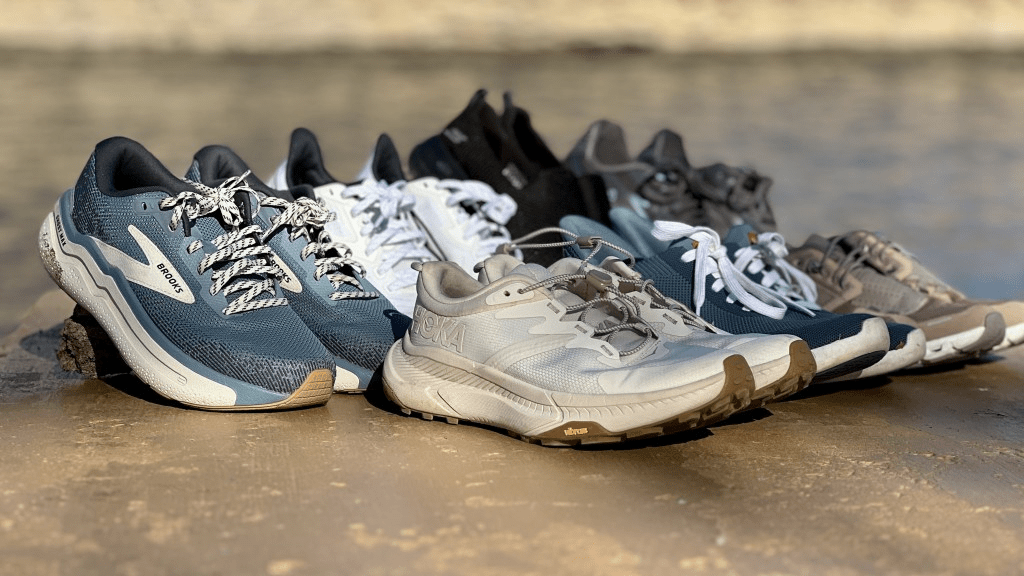 Assorted athletic shoes placed on a gym floor, illustrating different workout shoe types.